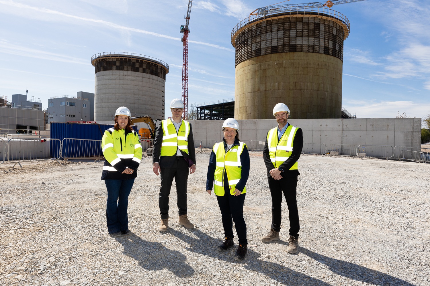 Four employees standing and smiling outside the Biomethane plant in Cork