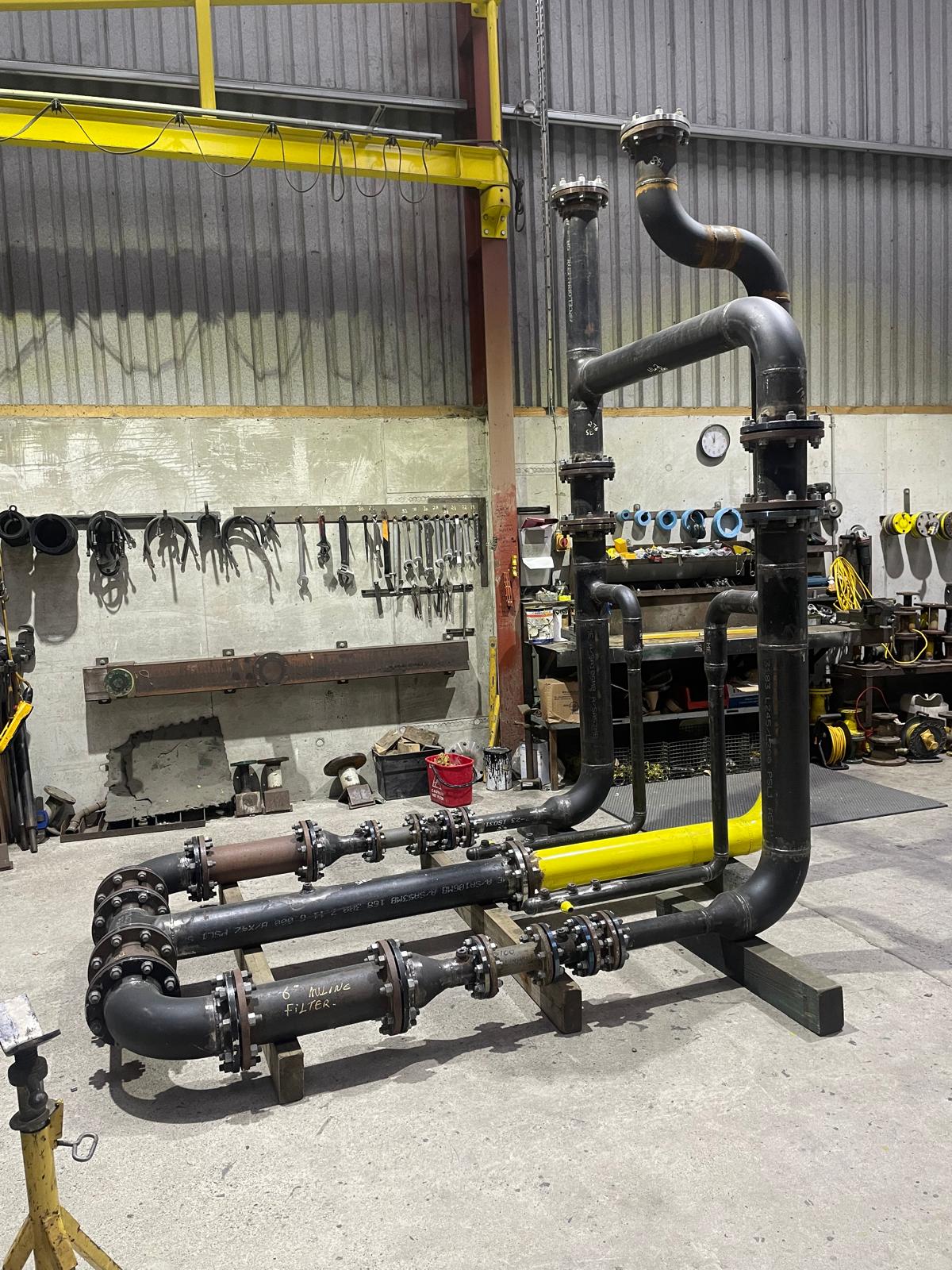 Large black pipes connected to each other as part of the Mater Private Project