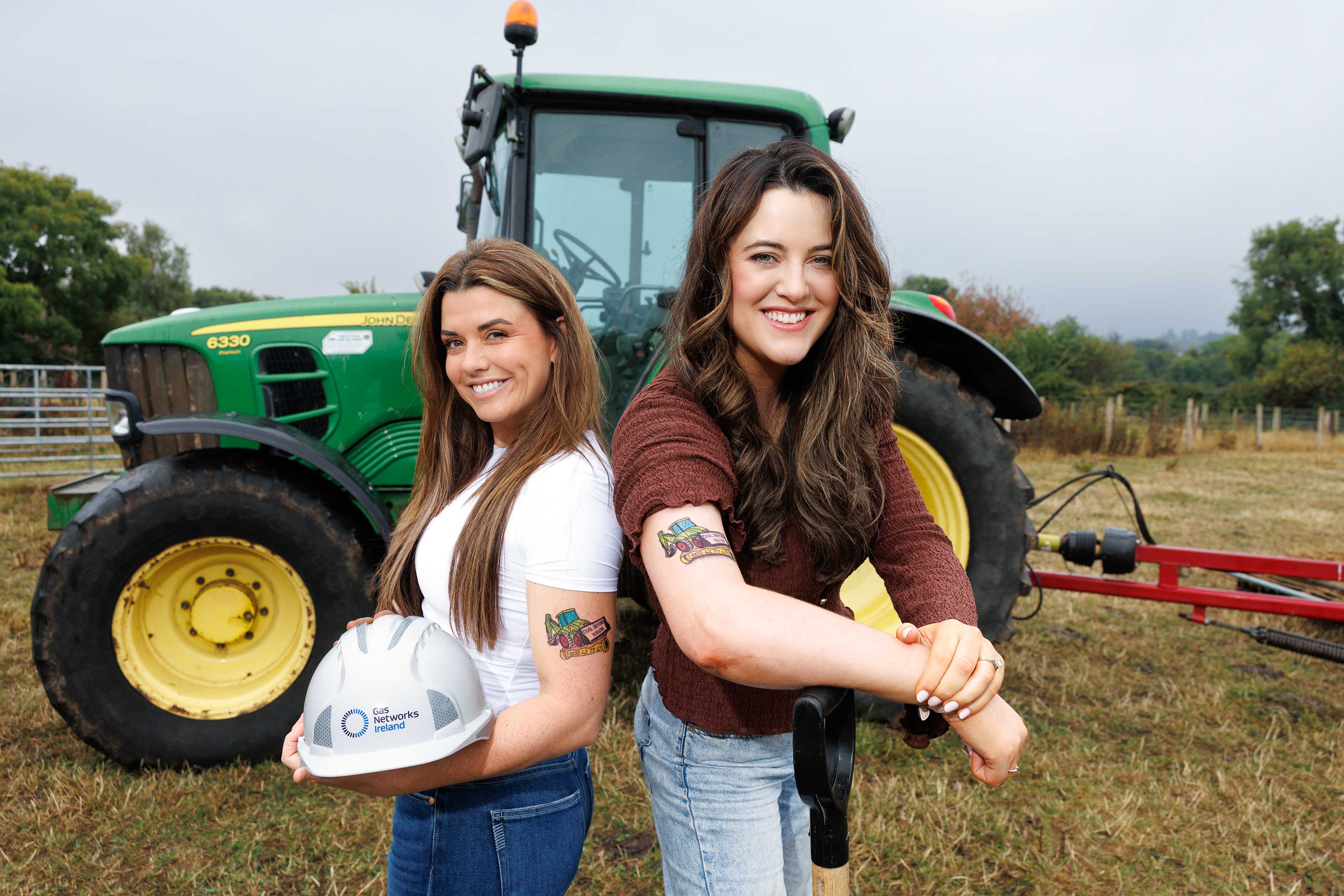 Two women showing their arms which host a temporary tattoo